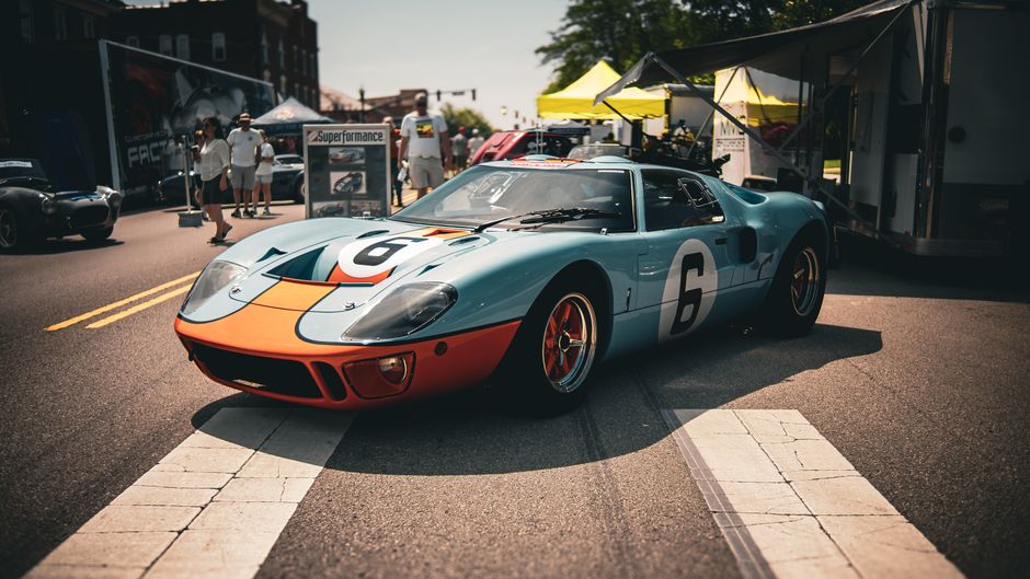 Classic blue and orange vintage race car showcased at an outdoor car show in London, Ohio.