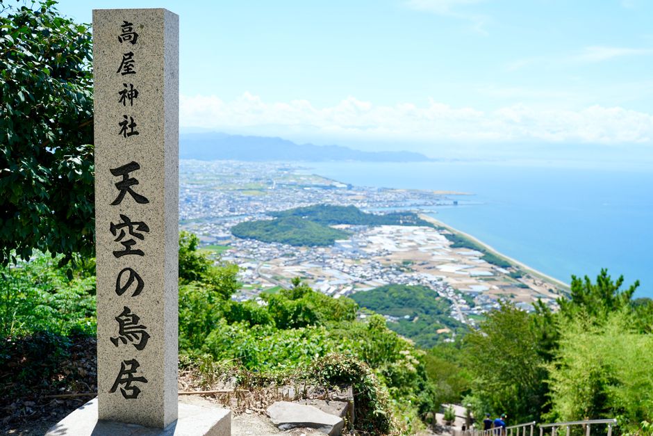 Scenic view from Takaya Shrine over Japanese coastline and city.